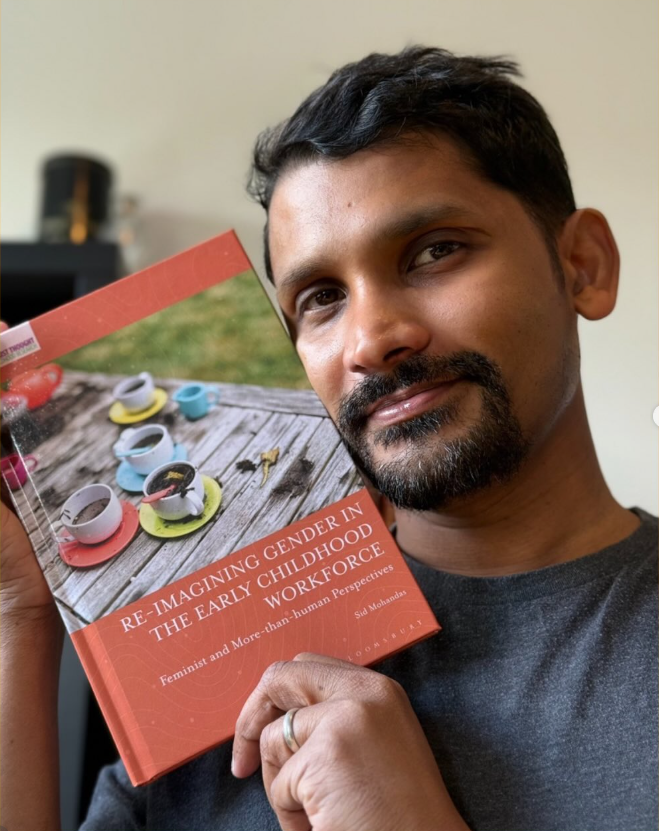 Dr Sid Mohandas holding Re-imagining Gender in the Early Childhood Workforce